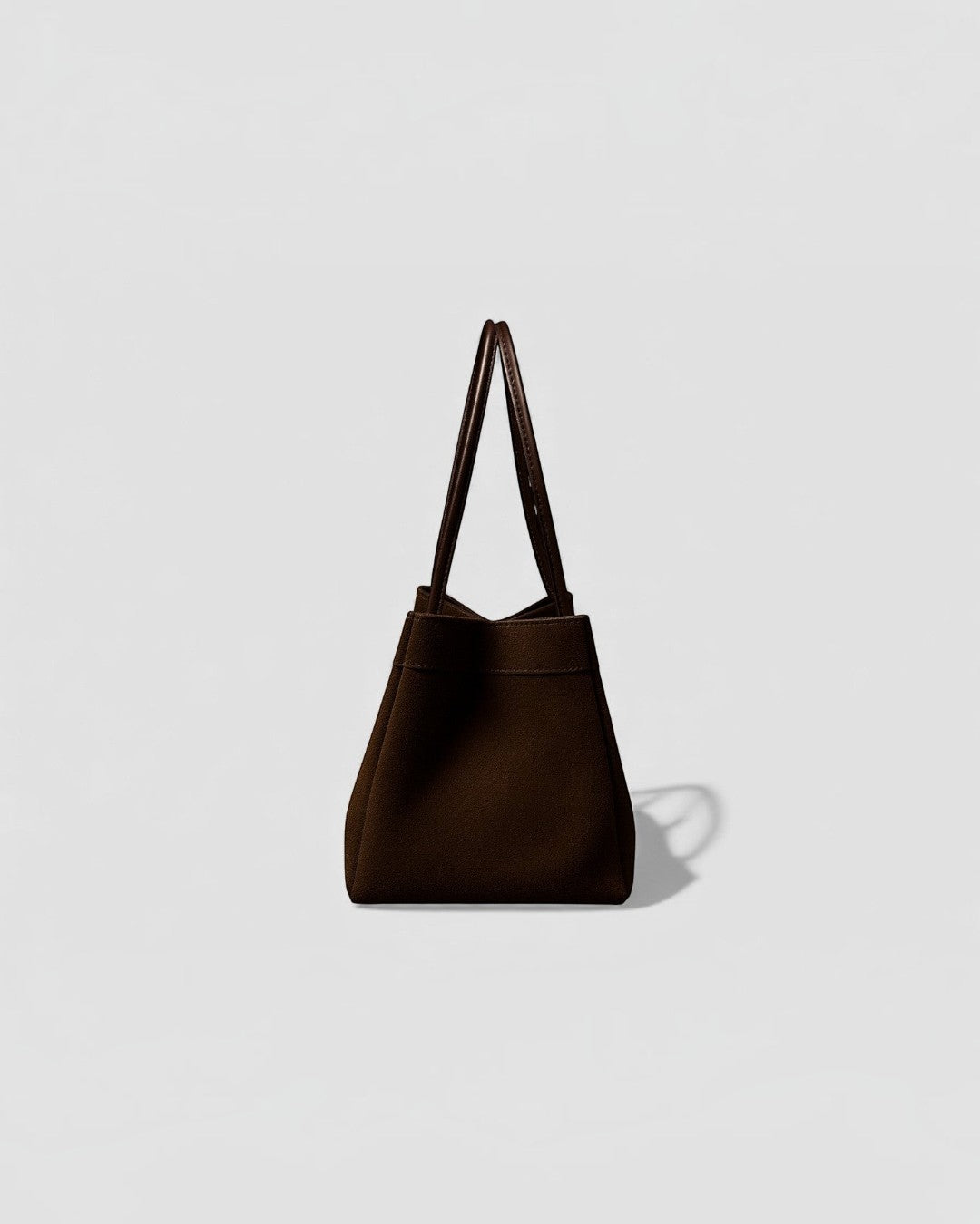 Pine Drew India Luna Umber handbag in suede-textured brown leather with architectural arc handles and structured shape.