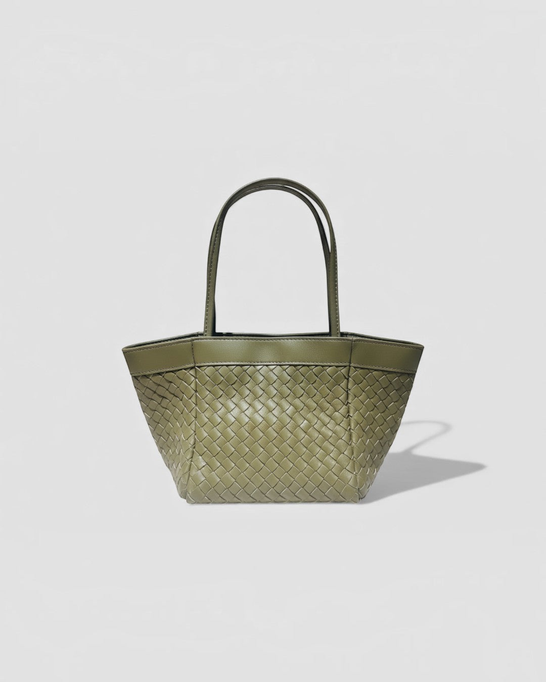 Pine Drew India Luna Verdura olive green woven leather handbag with architectural arc handles and structured base.