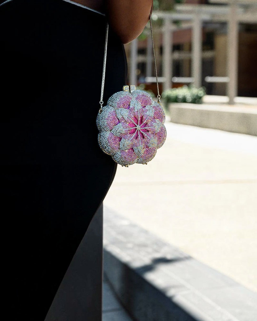 Pine Drew India pink floral clutch bag with sparkling rhinestone embellishments and a delicate silver chain strap.
