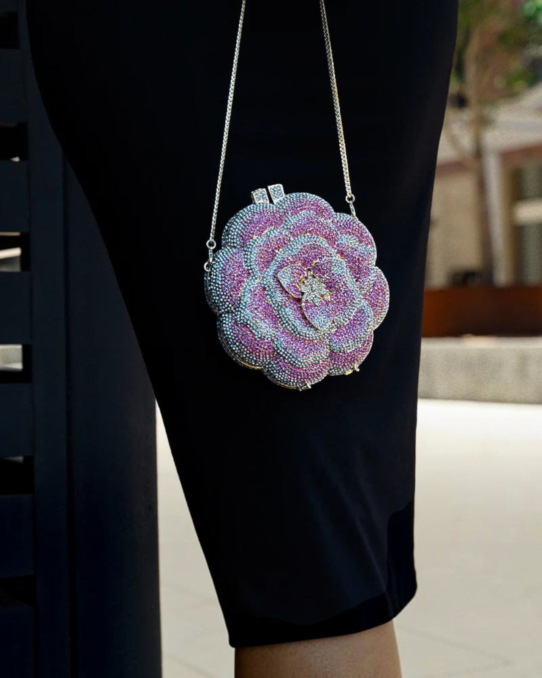 Pine Drew India pink floral clutch bag made of vegan leather and sparkling rhinestones with a silver chain strap.