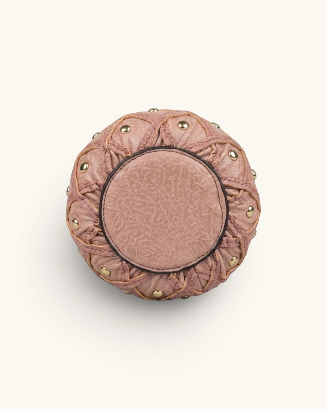 Pine Drew India Palmiera pineapple-shaped vegan leather clutch in dusty pink with gold stud accents, bottom view.