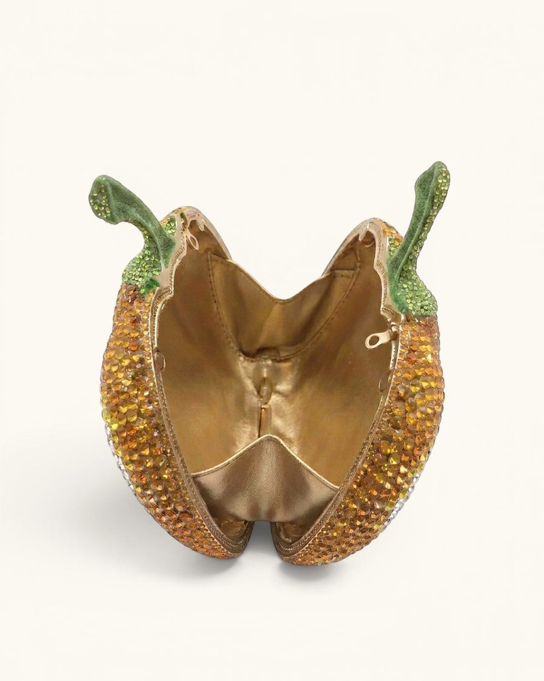 Pine Drew India pumpkin-shaped crystal clutch handbag with green stem detail and gold vegan leather interior