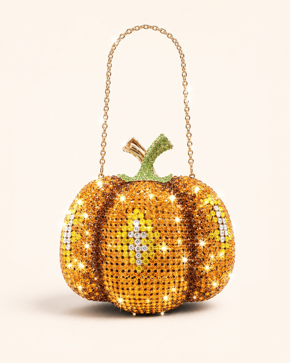 Pine Drew India pumpkin-shaped novelty clutch covered in orange and green crystals with a gold shoulder chain.