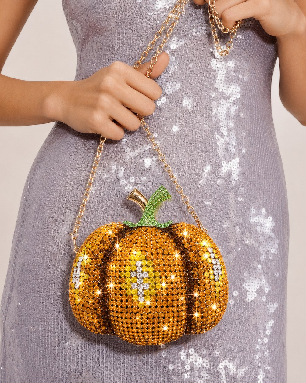 Pine Drew India pumpkin-shaped novelty clutch covered in orange and green crystals with a gold shoulder chain.