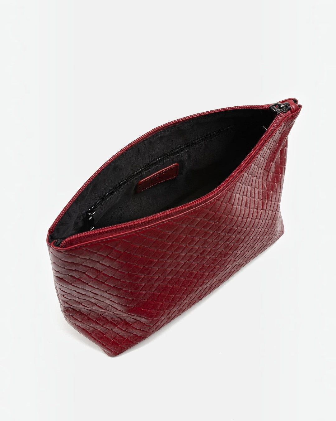 Pine Drew India Jocelyn handwoven red vegan leather pouch with a zippered top opening and black fabric interior.