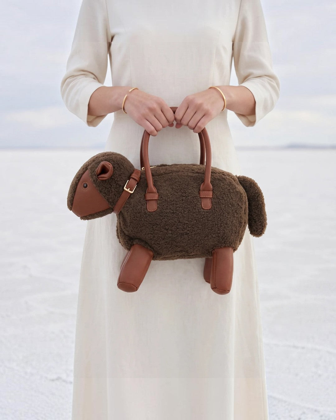Pine Drew India Montone Mini sheep-shaped bag in chocolate teddy shearling and tan vegan leather with gold hardware.