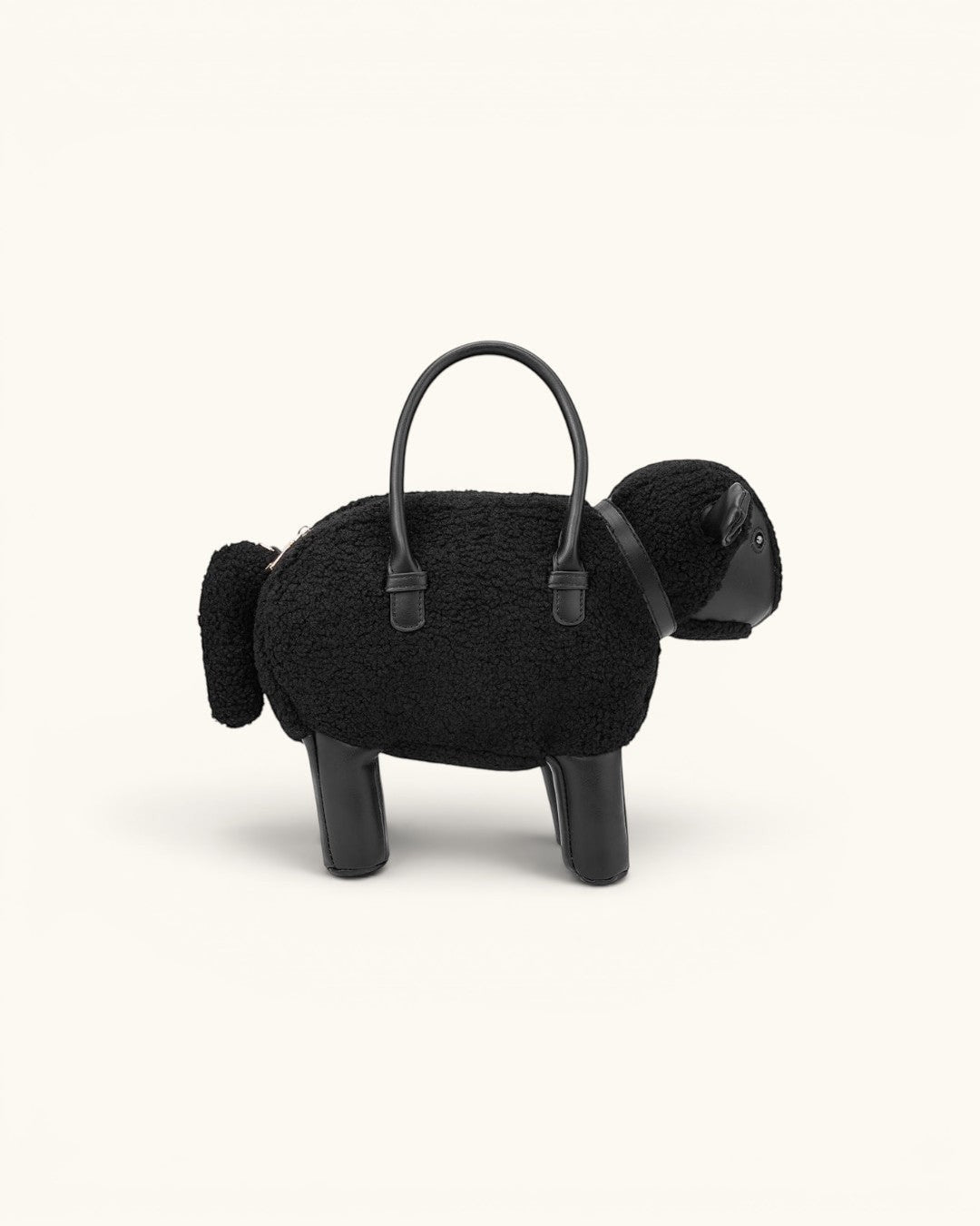 Pine Drew India Montone Mini sheep-shaped bag in black teddy shearling vegan leather with top handles and gold buckle.
