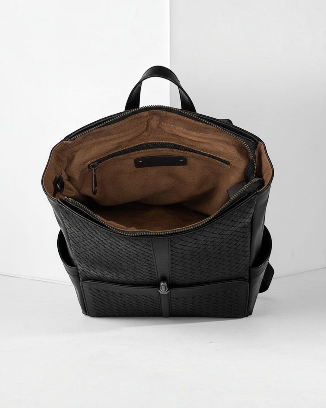 Pine Drew India Torrenzo Leather Grid Pack in black with a woven front panel, open top, and tan interior lining.