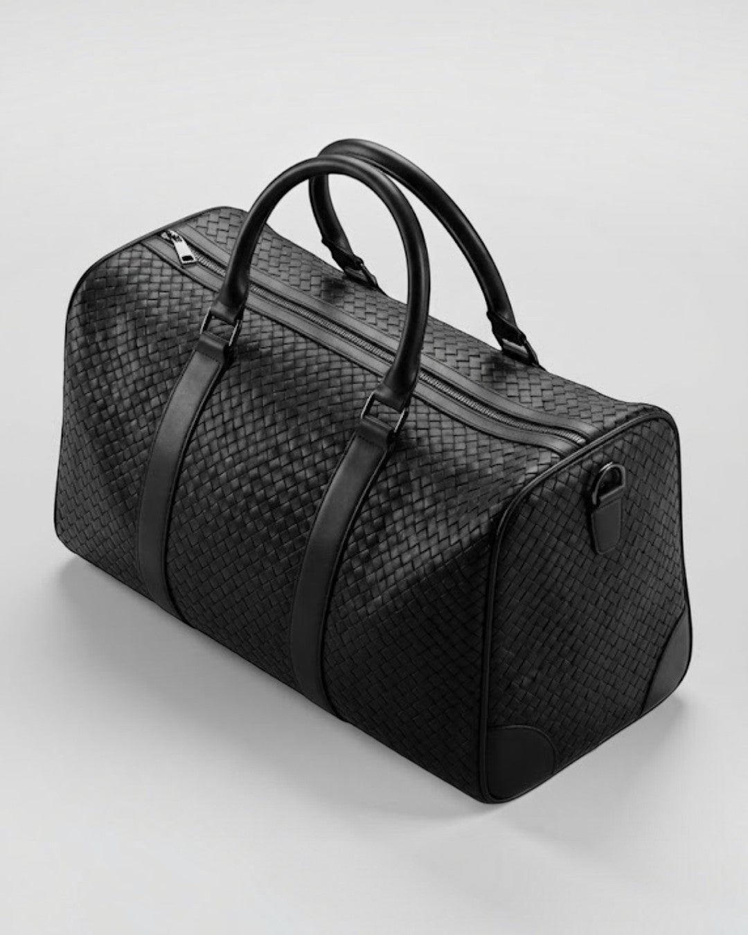 Pine Drew India Elora black vegan leather duffle bag with signature woven texture and reinforced carry handles